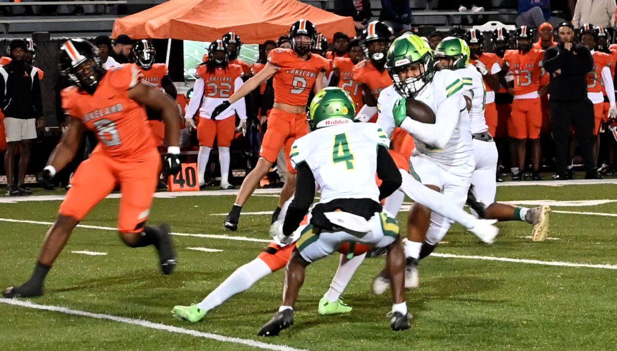 A Lake Minneola player breaks free from a tackle against Lakeland on Friday during a Class 4S, Region 3 final at Bryant Stadium.